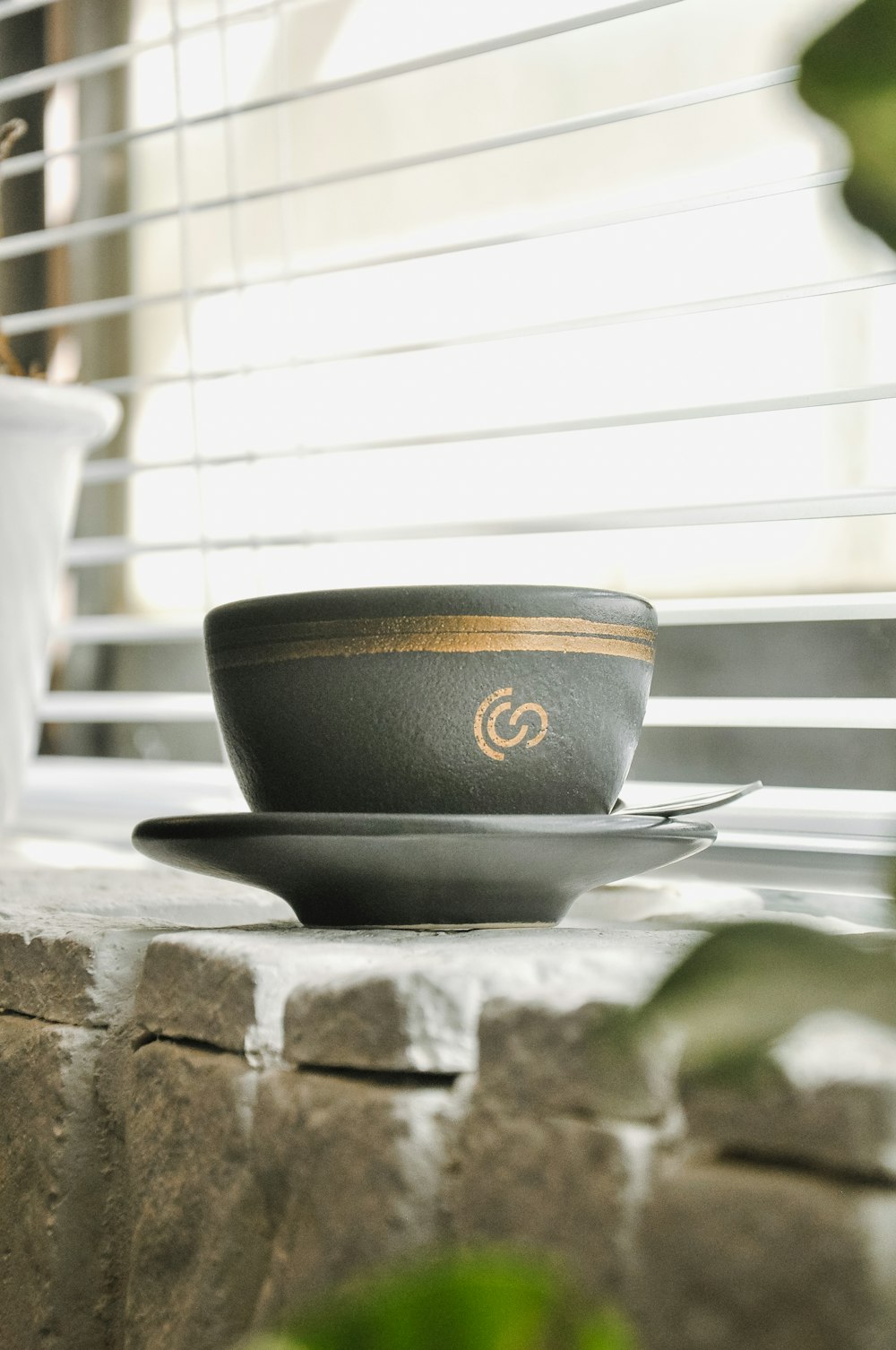 a black bowl on a stone ledge