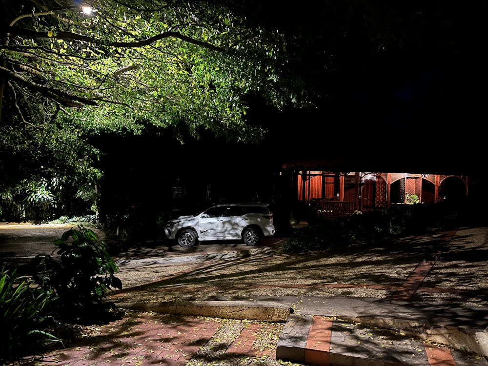 a car parked in front of a house at night