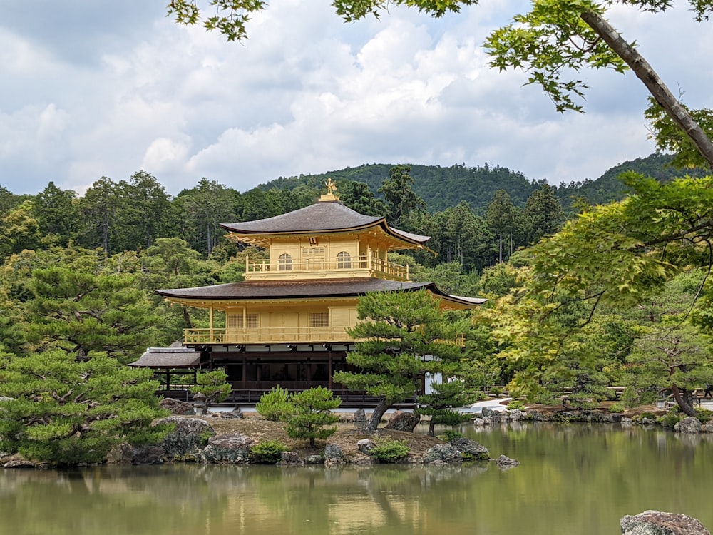 Kinkaku-ji with a gold roof by a body of water