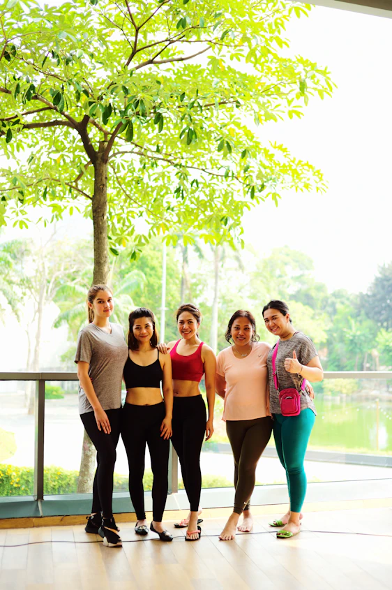 a group of people posing for a photo under a tree