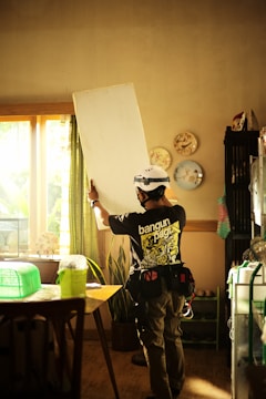 a man wearing a helmet and holding a white board