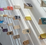 Warm white bookshelf showcasing tenacious mind collective titles with subtle forest green accents.