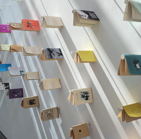 A display of diverse Scala Christ publications arranged artistically on a minimalist white shelf.