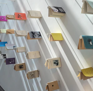 Books displayed on a minimalist shelf with a tosca green background.