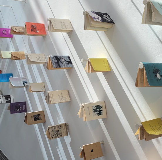 Artistic display of several photography books arranged on a minimalist black shelf, emphasizing their premium design and elegant spines.