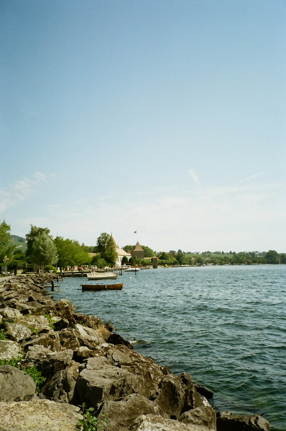 a body of water with a dock and a house on the other side