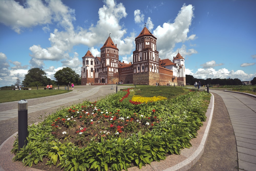 a large building with a garden in front of it