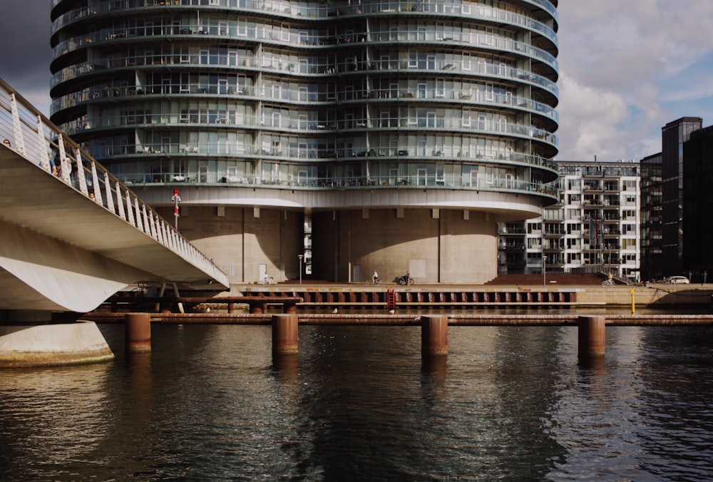 a bridge over water with buildings in the background