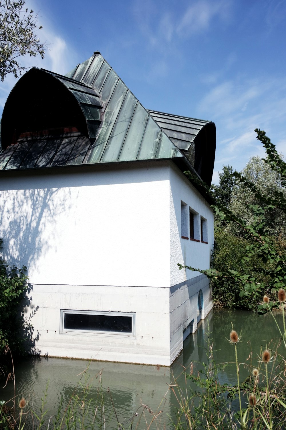 a white building with a black roof