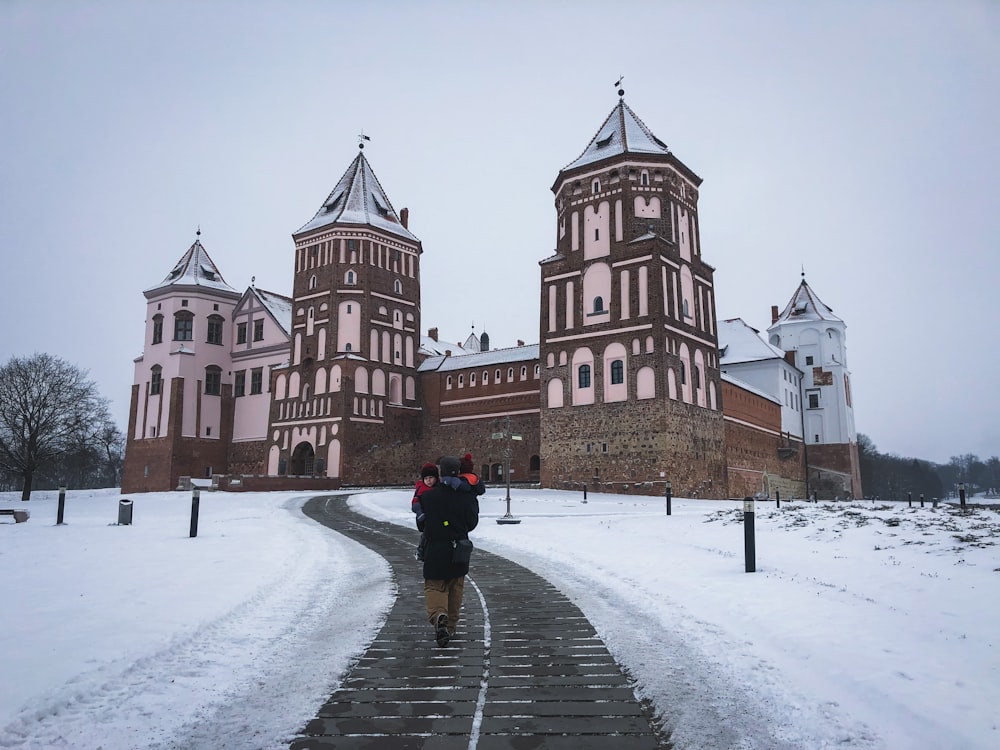 a person walking on a path in front of a large building