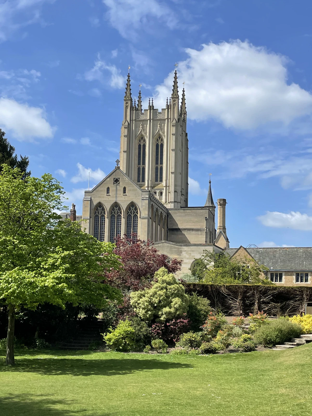 The tower of St Edmundsbury Cathedral above the flower beds of the Abbey Gardens in Bury St Edmunds