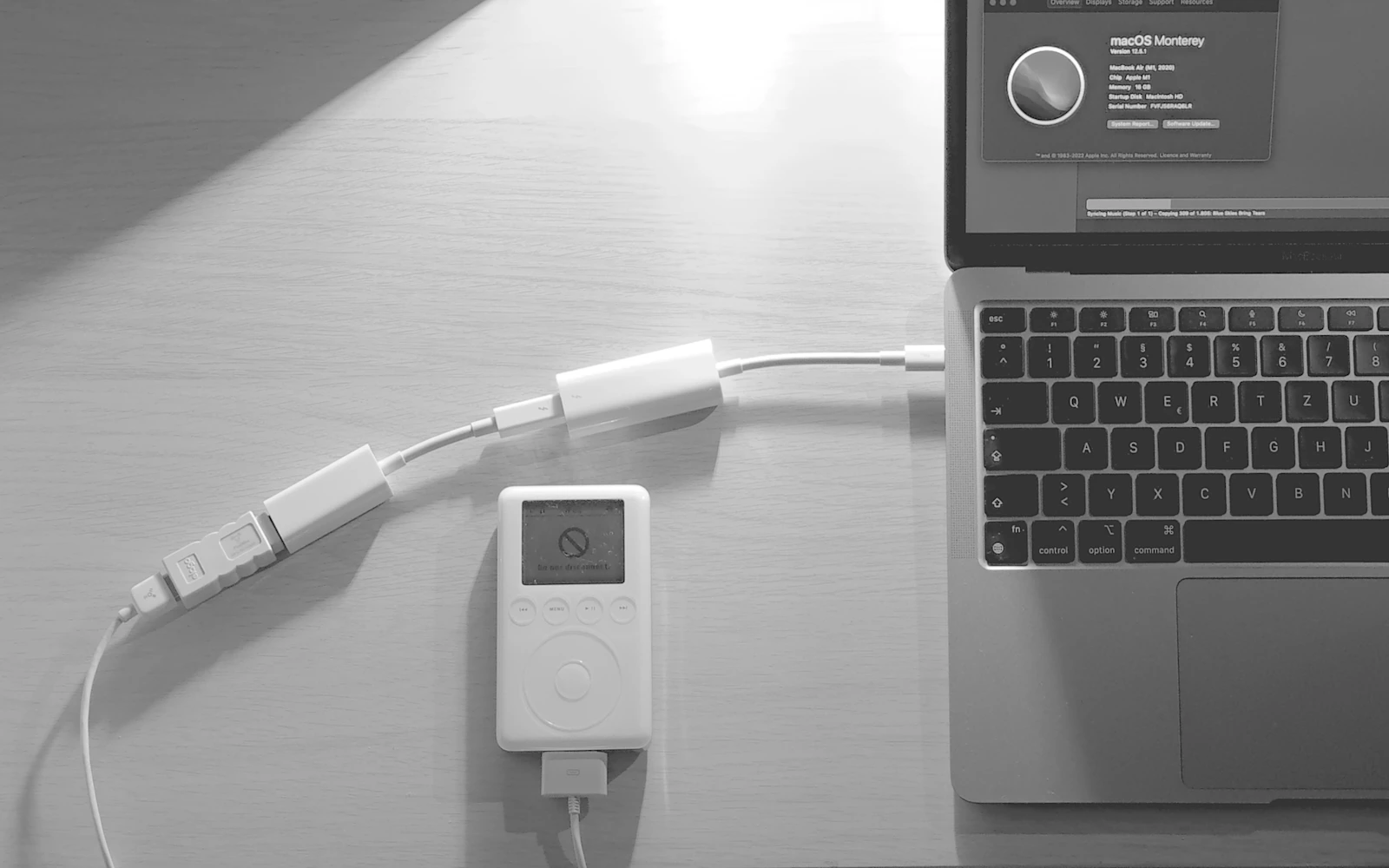 Laptop connected through a sequence of different adapters and cables