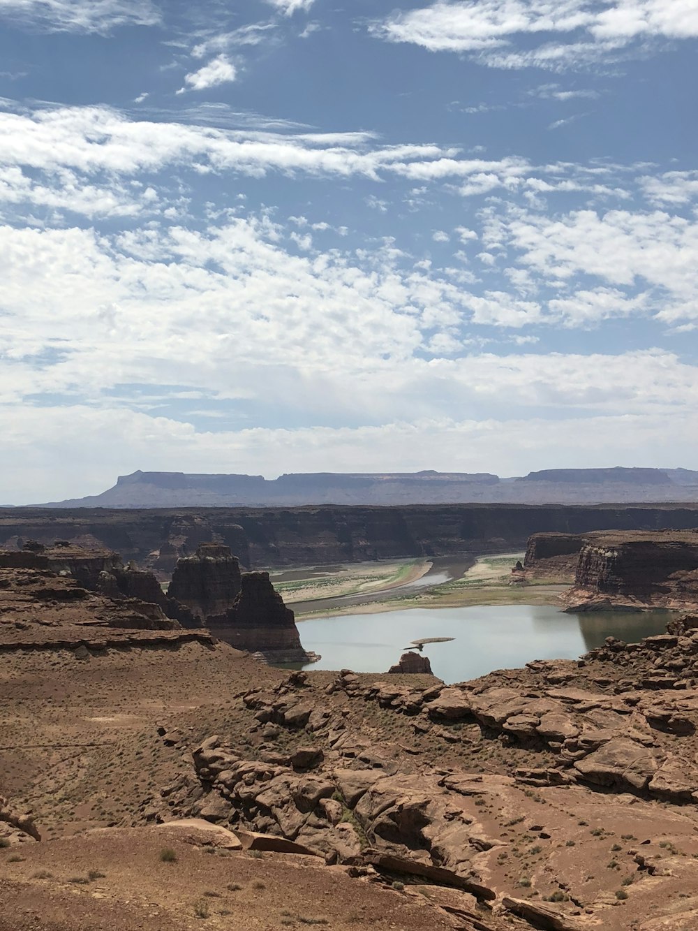 a rocky landscape with a body of water in the distance