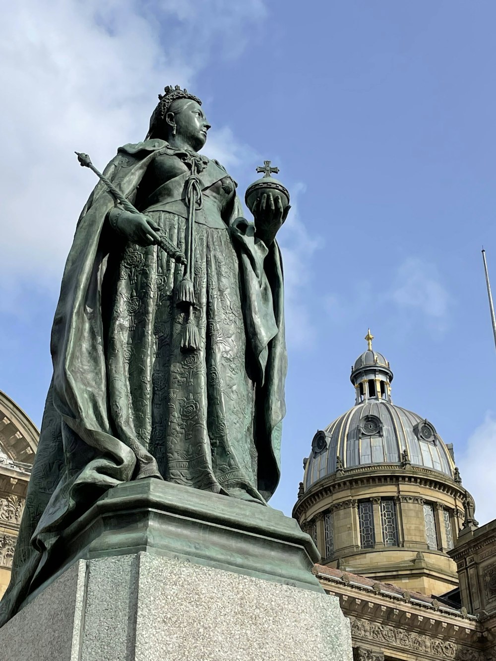 a statue of a person holding a staff