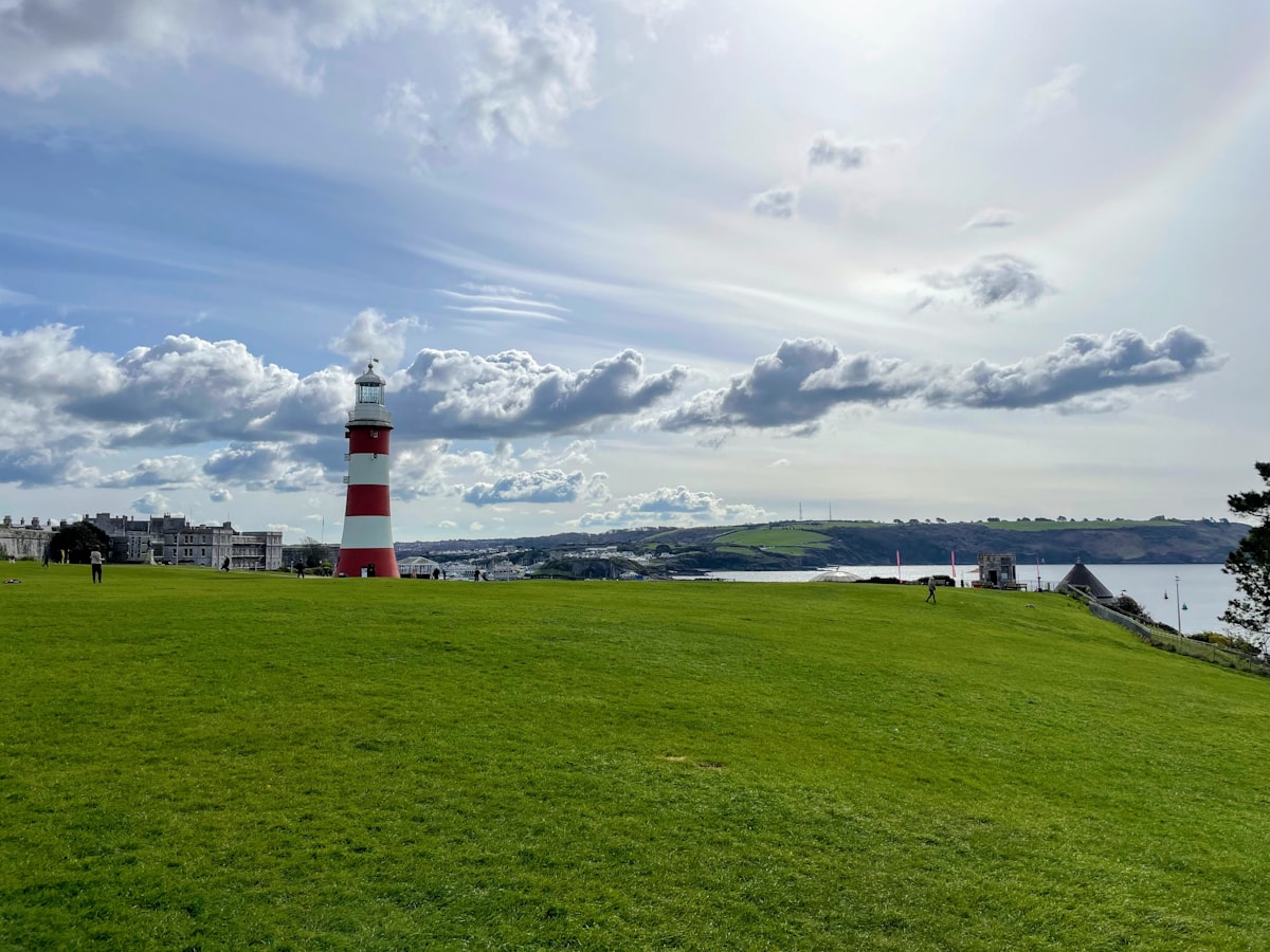 Smeaton's Tower lighthouse on the grassy slope of Plymouth Hoe overlooking the waterfront