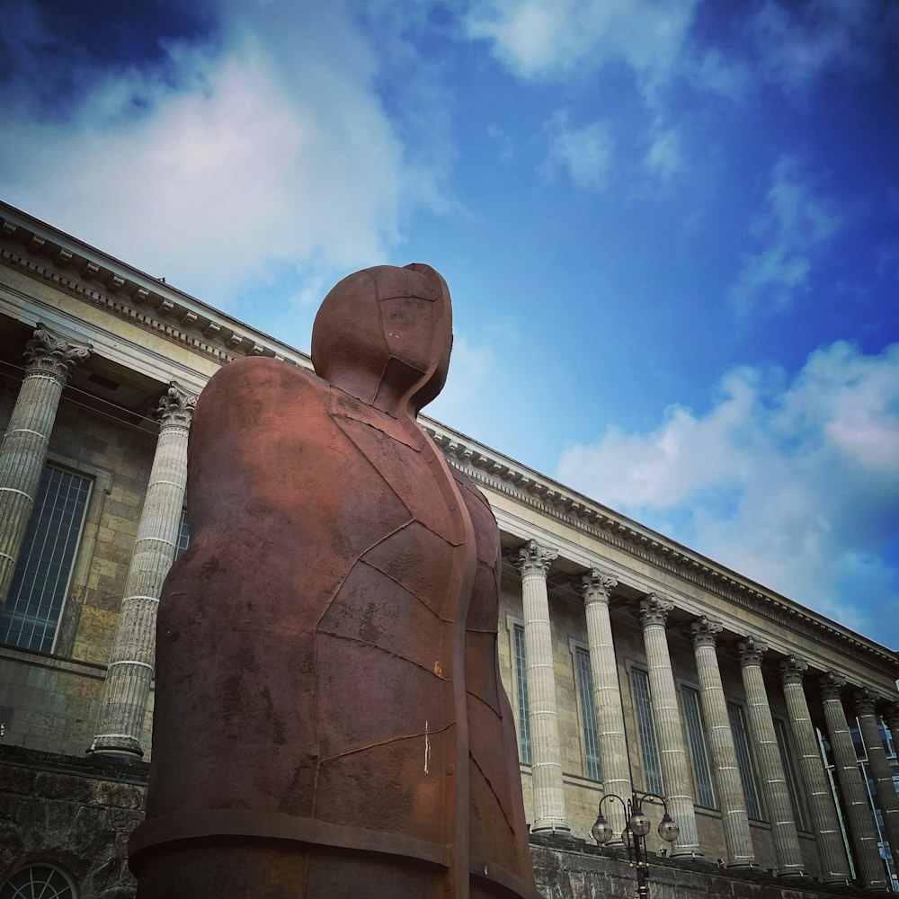 a statue of a person in front of a building