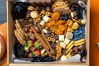 A vibrant assortment of wholesome snacks like roasted nuts and dried fruits in eco-friendly packaging.