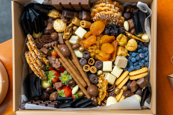 Elegant gift box filled with a colorful variety of nuts and healthy snacks.