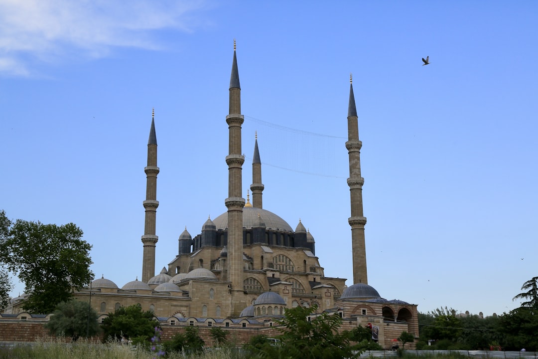 a large building with towers with Selimiye Mosque in the background,