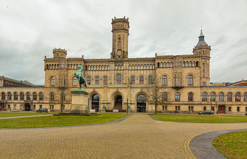 a large building with a statue in front of it