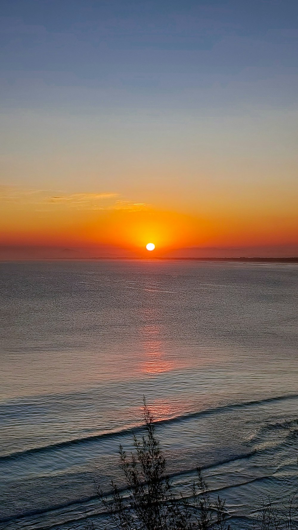 a sunset over a body of water