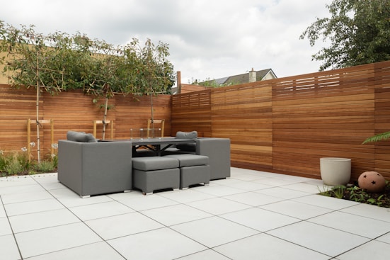 a patio with a couch and a table and chairs