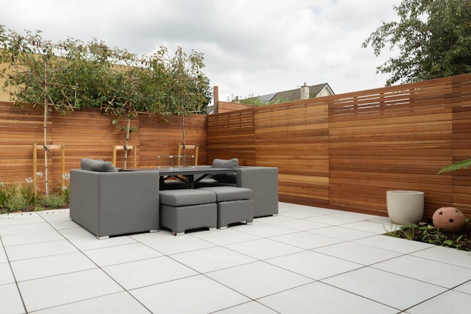 a patio with a couch and a table and chairs