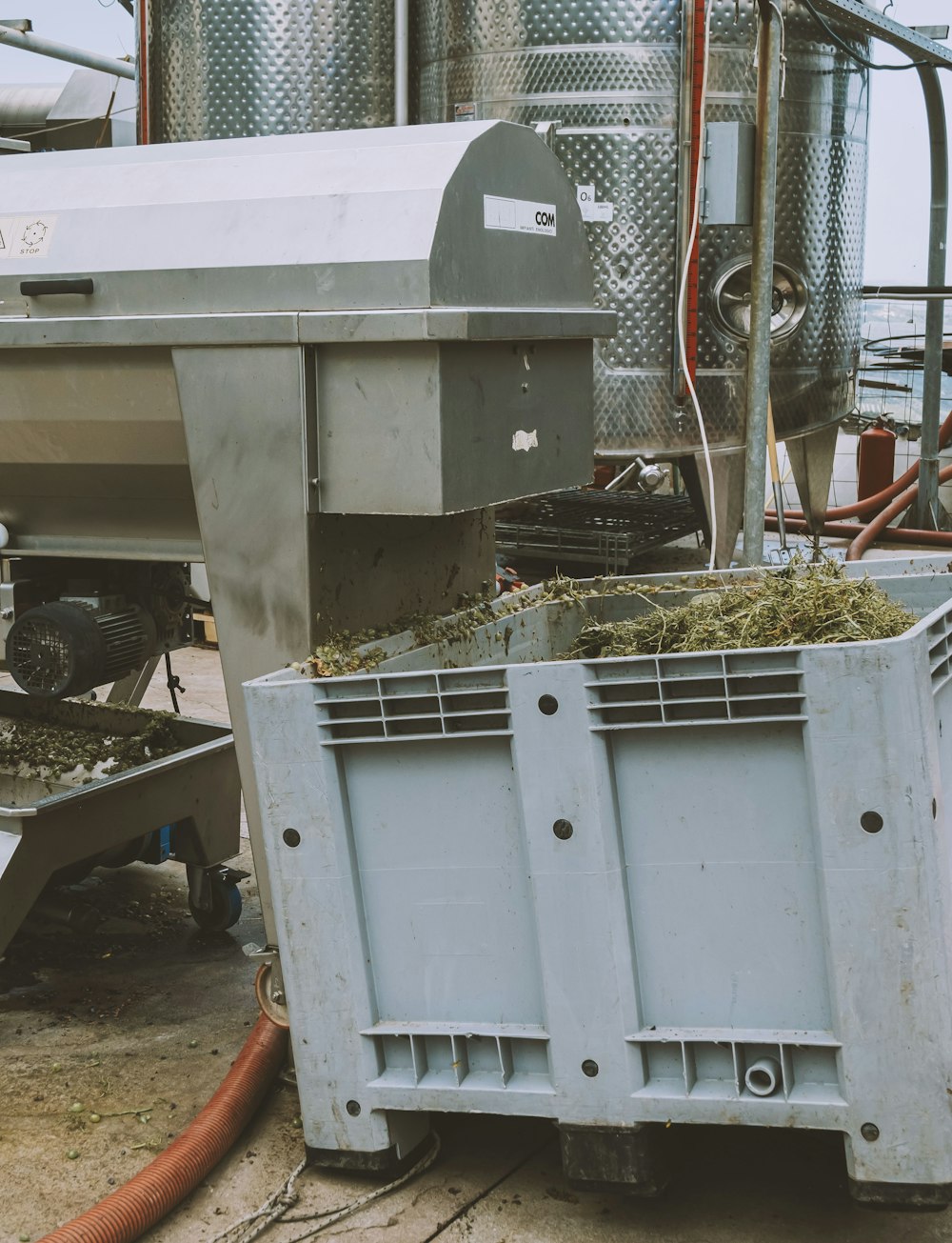 a large metal container with green plants