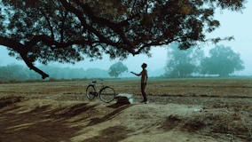 a person standing next to a bicycle
