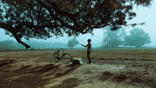 a person standing next to a bicycle