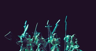 A group of skeleton warrior figurines holding various medieval weapons such as swords and axes. The scene is illuminated with a dramatic greenish light against a dark background, creating a mysterious and eerie atmosphere.