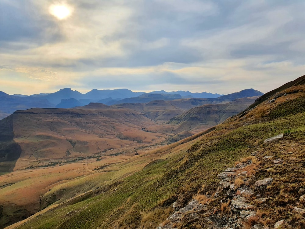 a valley with mountains in the background