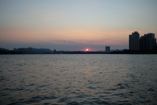 Sunset view over the iconic skyline of Hong Kong harbor.