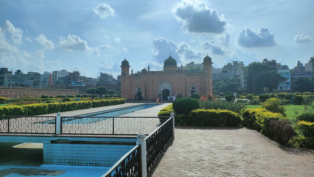 a large building with a pool in front of it