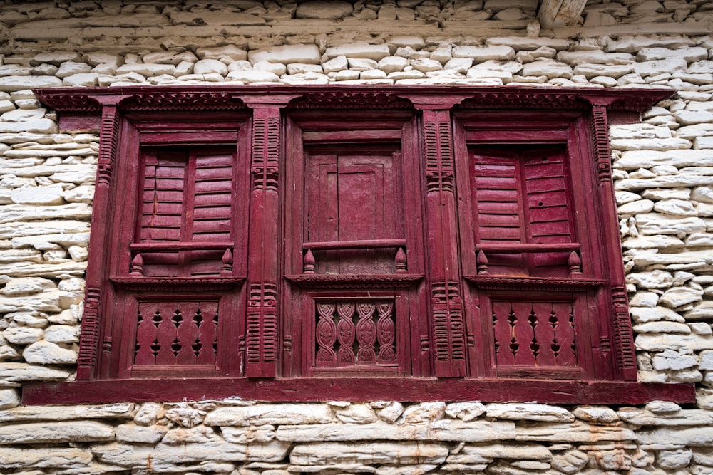 a red door on a stone building