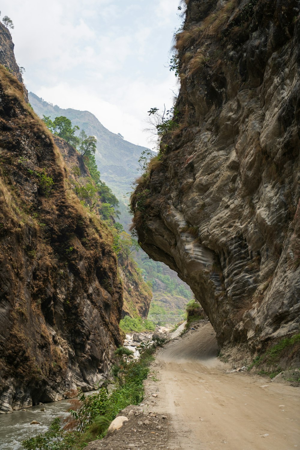 a dirt road between rocky cliffs