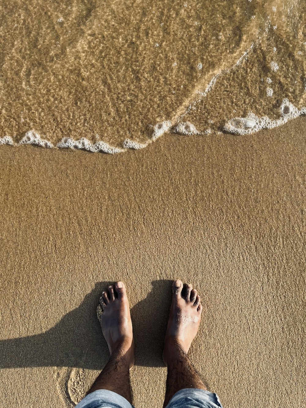a pair of feet on a beach