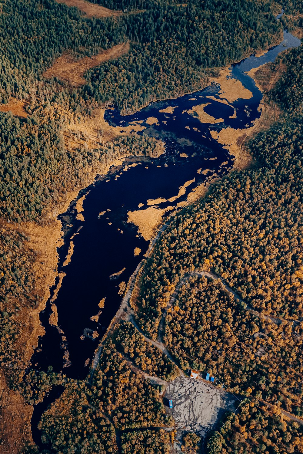 a stream of water with rocks and grass around it