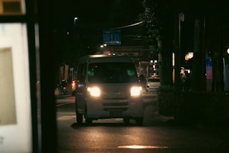 a white truck on a street at night
