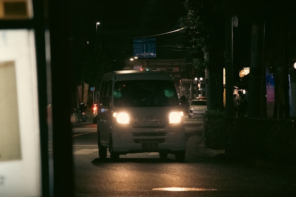 a white truck on a street at night