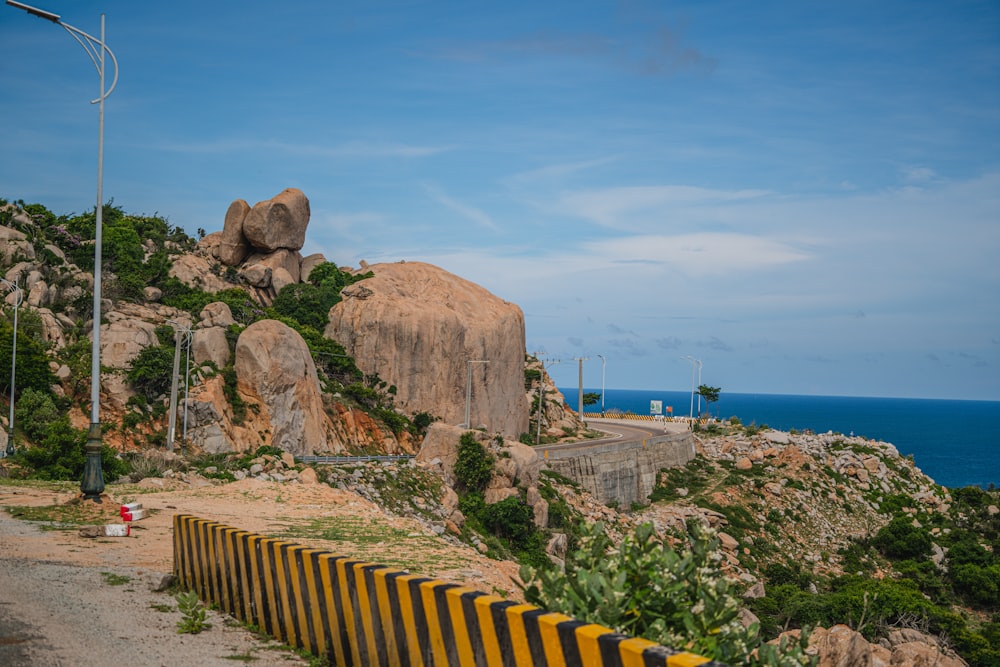 a road next to a rocky cliff