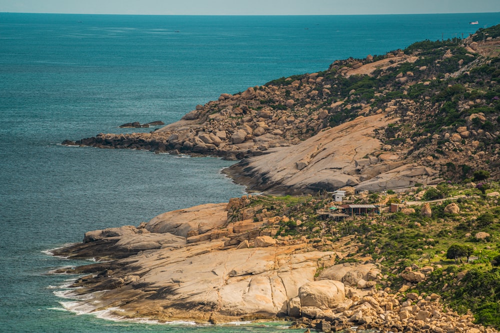 a rocky beach with a building on it