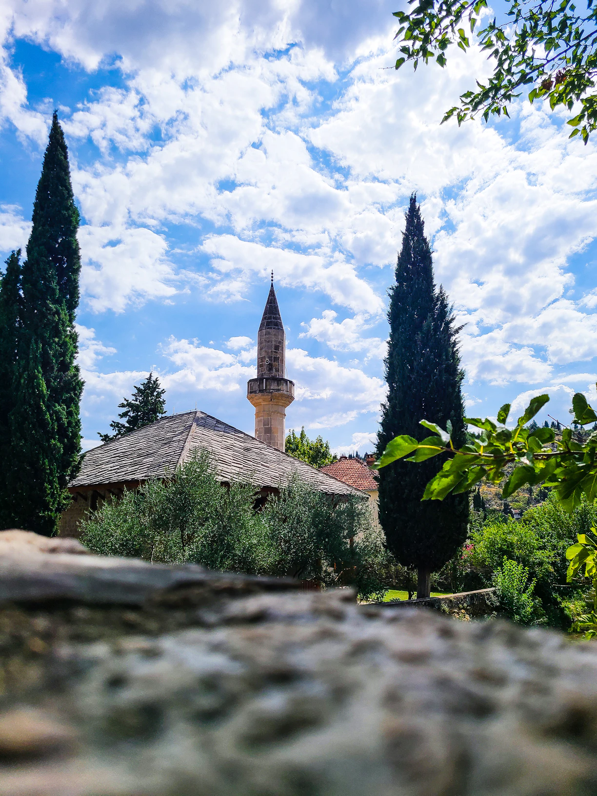 A serene morning scene of a traditional Malay village mosque surrounded by lush greenery.