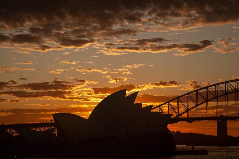 a bridge with a sunset in the background