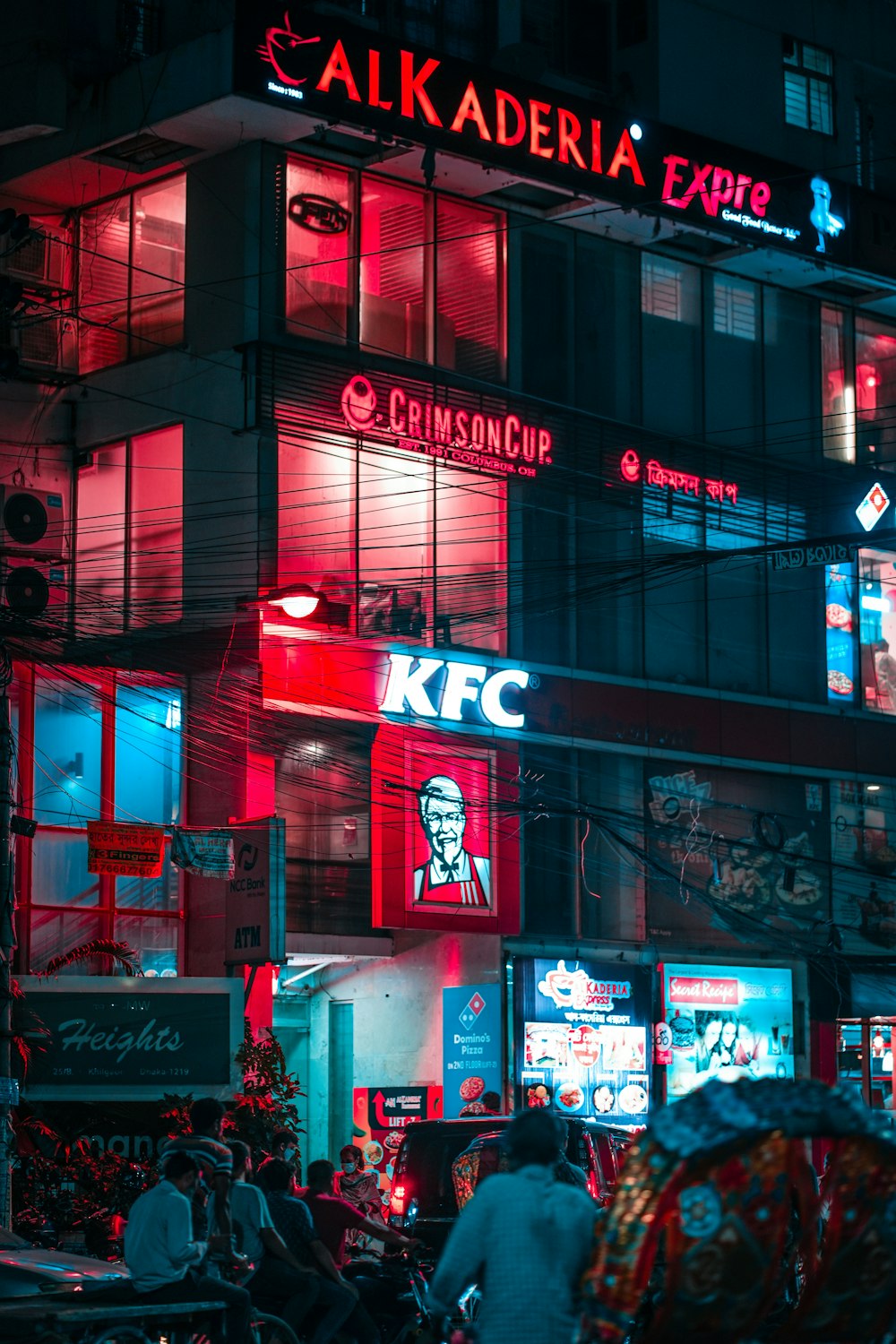 a building with many signs and people in front of it