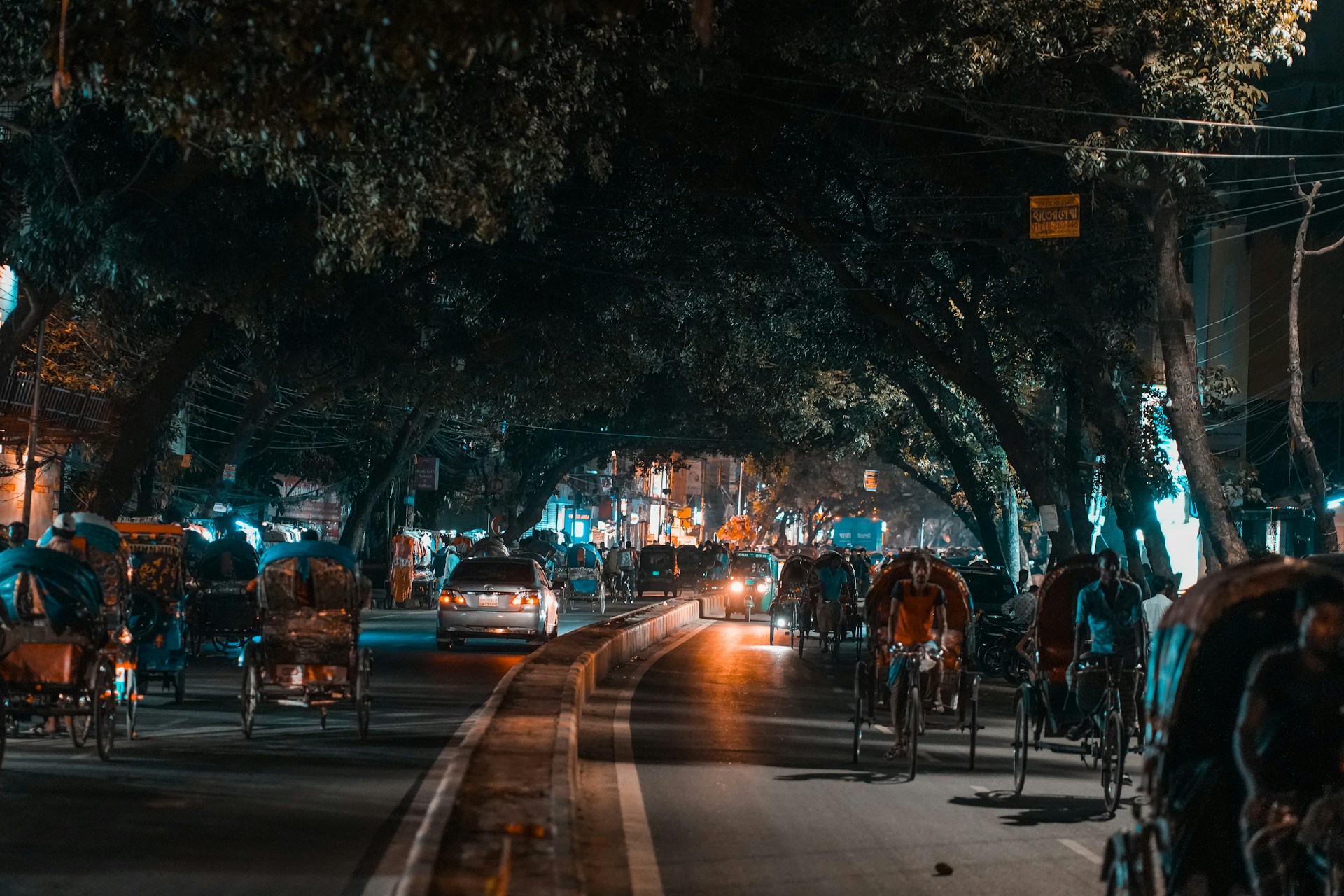 a busy street with cars and people