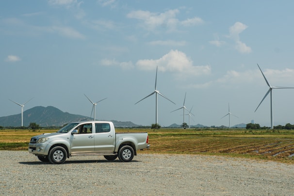 a truck parked in front of windmills
