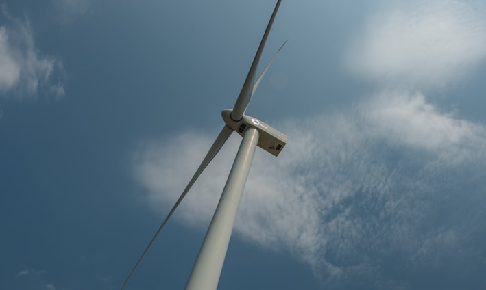 a wind turbine under a blue sky