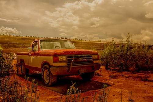 a red truck parked in a field
