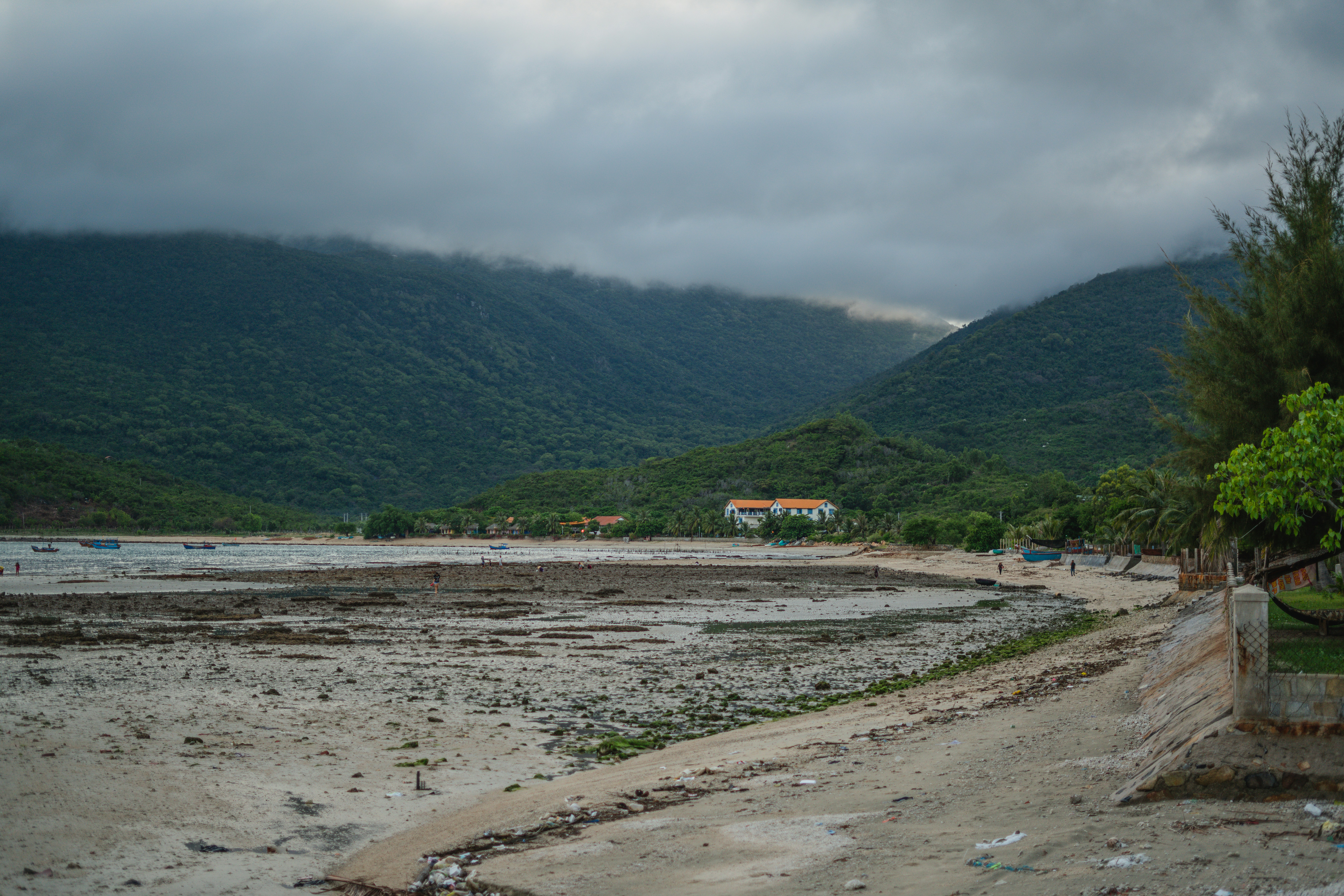 a dirt road with a house in the distance